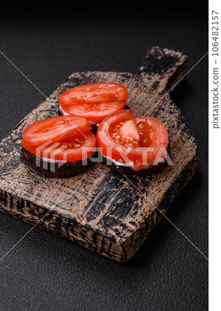 Delicious eggplant cut into circles grilled and cooked with mayonnaise and tomatoes Delicious eggplant cut into circles grilled and cooked with mayonnaise and tomatoes 106482157