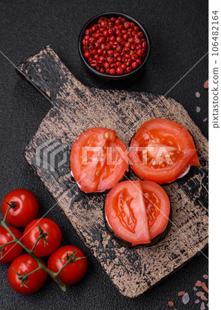 Delicious eggplant cut into circles grilled and cooked with mayonnaise and tomatoes 106482164