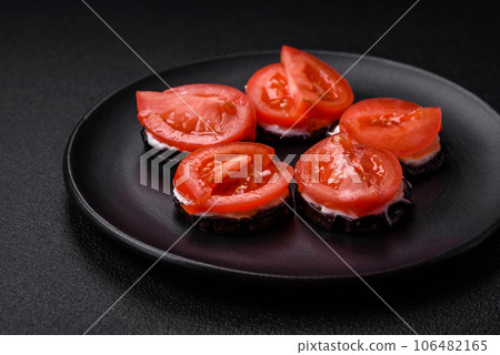 Delicious eggplant cut into circles grilled and cooked with mayonnaise and tomatoes 106482165