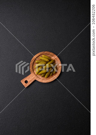 Delicious small pickled cucumbers gherkins with onions, mustard, salt and spices 106482206