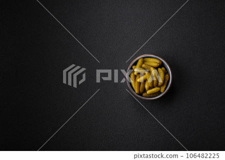 Delicious small pickled cucumbers gherkins with onions, mustard, salt and spices Delicious small pickled cucumbers gherkins with onions, mustard, salt and spices 106482225