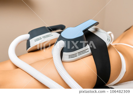 Young womans buttocks receive precise body sculpting treatment with specialized equipment 106482309