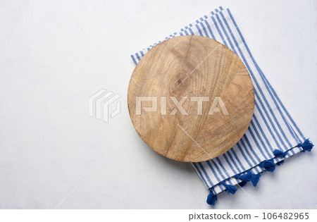 Empty round oak board on white table, top view 106482965