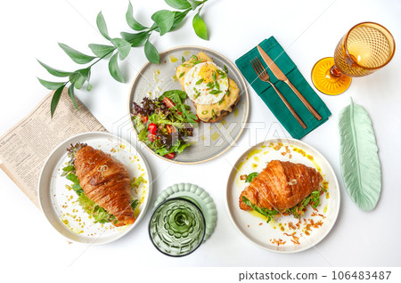 Set of breakfast dishes: croissants, toast, scrambled eggs, salad, bruschetta Set of breakfast dishes: croissants, toast, scrambled eggs, salad, bruschetta 106483487