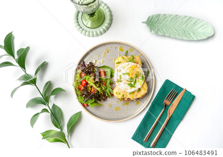 Set of breakfast dishes: croissants, toast, scrambled eggs, salad, bruschetta 106483491