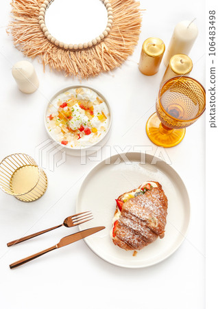 Delicious breakfast with fresh croissants and ripe berries on the white table 106483498