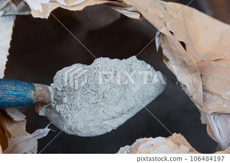 Cement powder with trowel put in bag package Cement powder with trowel put in bag package 106484197