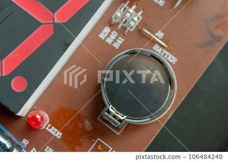 Lithium Battery Coin On Electronic circuit. 106484240