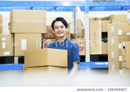 Young man working in a warehouse Young man working in a warehouse 106484967
