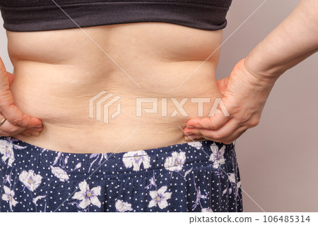 [Back view of a housewife picking meat from her side] 106485314