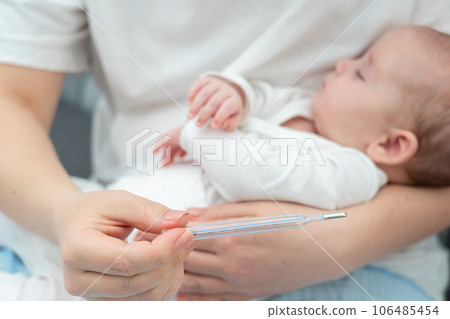 Classic thermometer in action, Concept of newborn health monitoring 106485454