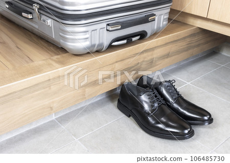 Business shoes and a suitcase. image of business trip Business shoes and a suitcase. image of business trip 106485730
