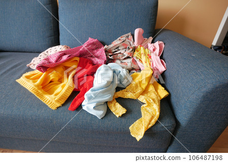 Messy clothes on sofa at home  106487198