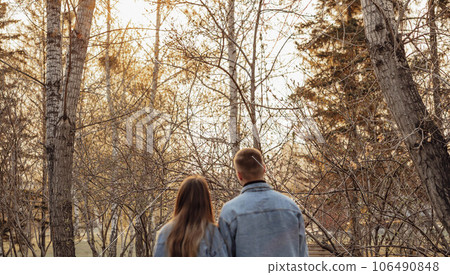 A couple in motion walks in the park in spring or autumn, happy lifestyle concept A couple in motion walks in the park in spring or autumn, happy lifestyle concept 106490848