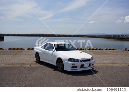 90's sports car, white R34GT-R with the sea in the background 90's sports car, white R34GT-R with the sea in the background 106491113