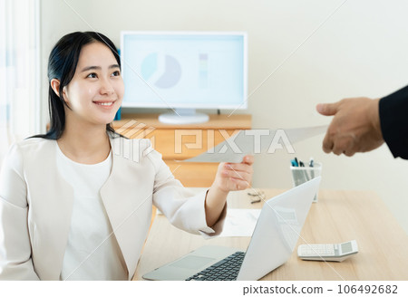 Young woman presenting documents in the office Young woman presenting documents in the office 106492682