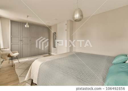 a bedroom with a bed, chair and tv in the corner room on the right hand side of the room 106492856