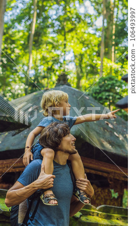Dad and son travelers discovering Ubud forest in Monkey forest, Bali Indonesia. Traveling with children concept VERTICAL FORMAT for Instagram mobile story or stories size. Mobile wallpaper 106493997