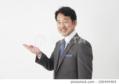 中年商人用手掌、白色背景指著左邊 106494464