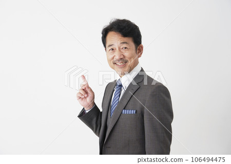 Middle-aged businessman pointing to the left, white background Middle-aged businessman pointing to the left, white background 106494475