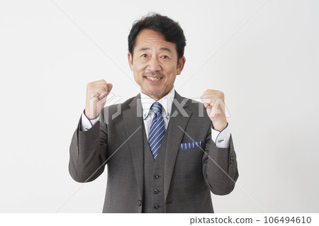 Middle-aged businessman fist-pumping white background Middle-aged businessman fist-pumping white background 106494610