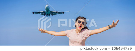 Woman have fun on the beach watching the landing planes. Traveling on an airplane concept. Text space. Island Phuket in Thailand. Impressive paradise. Hot beach Mai Khao. Amazing landscape BANNER 106494789