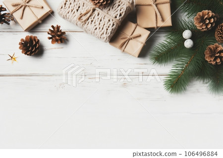 Christmas composition. Christmas gift, knitted blanket, pine cones, fir branches on wooden white background. Flat lay, top view, copy space 106496884