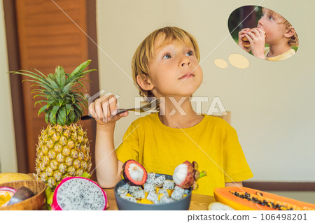 Boy eats fruit but dreams about hamburger. Harmful and healthy food for children. Child eating healthy snack. Vegetarian nutrition for kids. Vitamins for children. Junk food concept Boy eats fruit but dreams about hamburger. Harmful and healthy food for children. Child eating healthy snack. Vegetarian nutrition for kids. Vitamins for children. Junk food concept 106498201