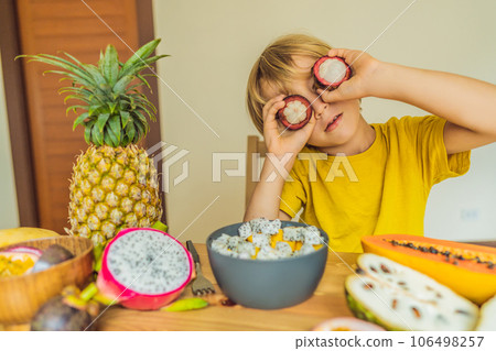 Boy eats fruit. Healthy food for children. Child eating healthy snack. Vegetarian nutrition for kids. Vitamins for children 106498257
