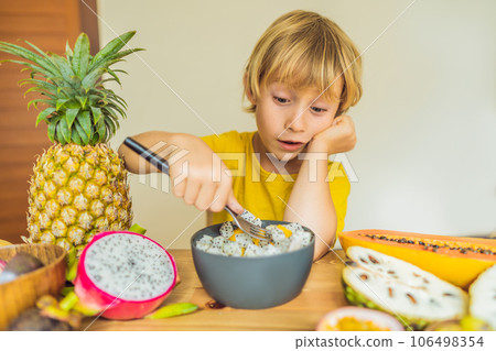 Boy eats fruit. Healthy food for children. Child eating healthy snack. Vegetarian nutrition for kids. Vitamins for children Boy eats fruit. Healthy food for children. Child eating healthy snack. Vegetarian nutrition for kids. Vitamins for children 106498354