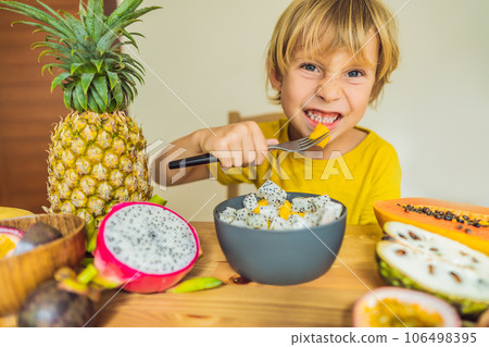 Boy eats fruit. Healthy food for children. Child eating healthy snack. Vegetarian nutrition for kids. Vitamins for children 106498395