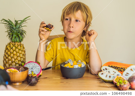 Boy eats fruit. Healthy food for children. Child eating healthy snack. Vegetarian nutrition for kids. Vitamins for children Boy eats fruit. Healthy food for children. Child eating healthy snack. Vegetarian nutrition for kids. Vitamins for children 106498498
