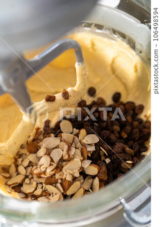 Mixing ingredients in kitchen mixer to bake mini Easter bread kulich. Mixing ingredients in kitchen mixer to bake mini Easter bread kulich. 106498594