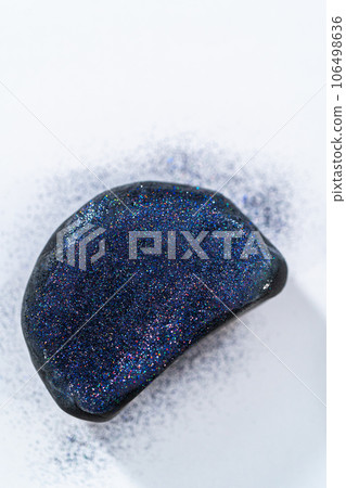 Applying glitter to panda's ears to make panda pumpkin for Halloween. Applying glitter to panda's ears to make panda pumpkin for Halloween. 106498636