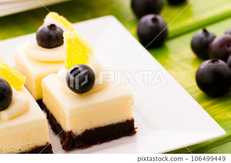 Small white chocolate cheesecake squares at dessert bar. 106499449