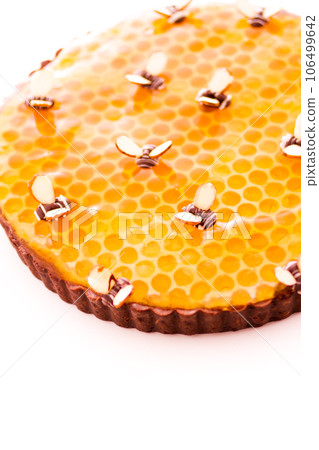 White chocolate lemon honey tart on a white background. 106499642