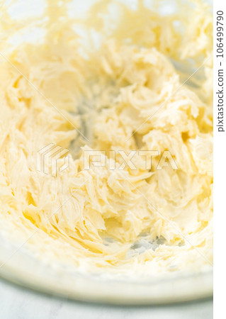 Close up view. Mixing ingredients in a glass mixing bowl to bake mascarpone tart with fresh berries. Close up view. Mixing ingredients in a glass mixing bowl to bake mascarpone tart with fresh berries. 106499790