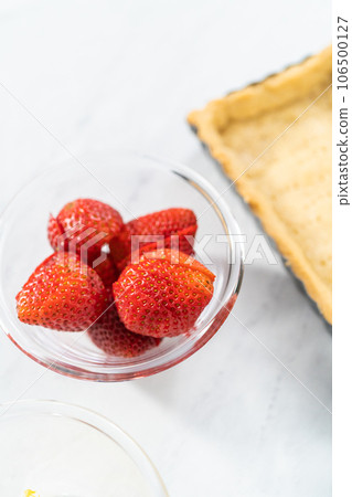 Close up view. Filling mascarpone tart with cheese filling and decorating with fresh berries. Close up view. Filling mascarpone tart with cheese filling and decorating with fresh berries. 106500127