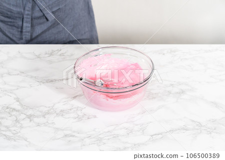 Mixing food coloring into the meringue to bake meringue cookies. Mixing food coloring into the meringue to bake meringue cookies. 106500389