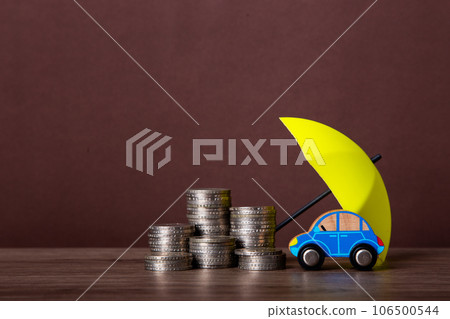 Umbrella and toy car with copy space. Umbrella and toy car with copy space. 106500544