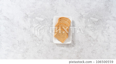 Flat lay. Stale bread on a white plate to make bread crumbs. 106500559