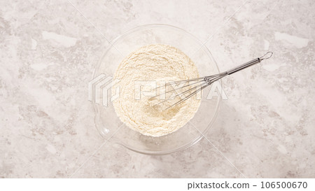 Flat lay. Step by step. Mixing ingredients in a glass mixing bowl to prepare coconut banana pancakes. Flat lay. Step by step. Mixing ingredients in a glass mixing bowl to prepare coconut banana pancakes. 106500670