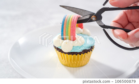 Step by step. Chocolate cupcakes decorated with blue buttercream frosting and rainbow for unicorn theme birthday party. Step by step. Chocolate cupcakes decorated with blue buttercream frosting and rainbow for unicorn theme birthday party. 106500879