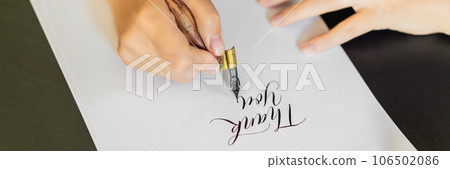 Calligrapher hands writes phrase on white paper. Phrase - Thank you. Inscribing ornamental decorated letters. Calligraphy, graphic design, lettering, handwriting, creation concept BANNER, LONG FORMAT Calligrapher hands writes phrase on white paper. Phrase - Thank you. Inscribing ornamental decorated letters. Calligraphy, graphic design, lettering, handwriting, creation concept BANNER, LONG FORMAT 106502086