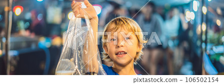 Young boy tourist on Walking street Asian food market BANNER, LONG FORMAT Young boy tourist on Walking street Asian food market BANNER, LONG FORMAT 106502154