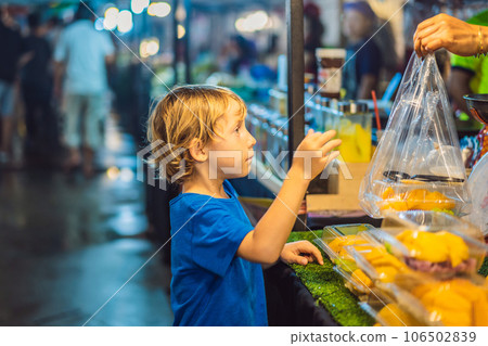 Young boy tourist on Walking street Asian food market Young boy tourist on Walking street Asian food market 106502839