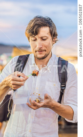 Young man tourist on Walking street Asian food market VERTICAL FORMAT for Instagram mobile story or stories size. Mobile wallpaper Young man tourist on Walking street Asian food market VERTICAL FORMAT for Instagram mobile story or stories size. Mobile wallpaper 106502887