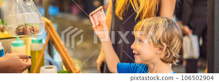 Mother and son are tourists on Walking street Asian food market BANNER, LONG FORMAT 106502904