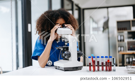 Modern medical research laboratory. female scientist working with micro pipettes analyzing biochemical samples, advanced science chemical laboratory . 106502951