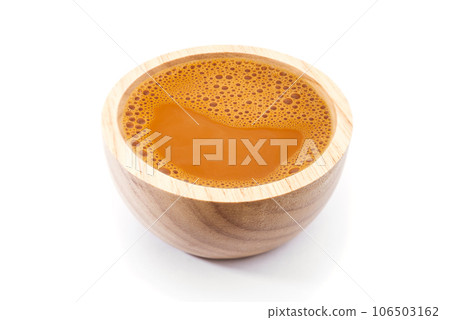 Hot milk tea in a wooden cup on white 106503162